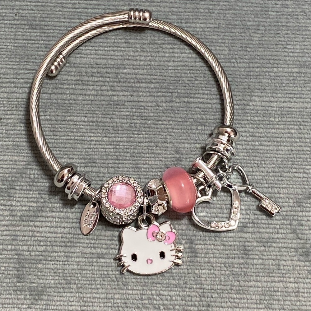 NWOT Sanrio Hello Kitty bangle bracelet, silver with many charms,expandable band